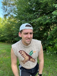 a man wearing a sweater with a bird on it