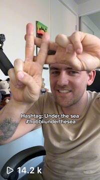 a man is making a peace sign with his hands